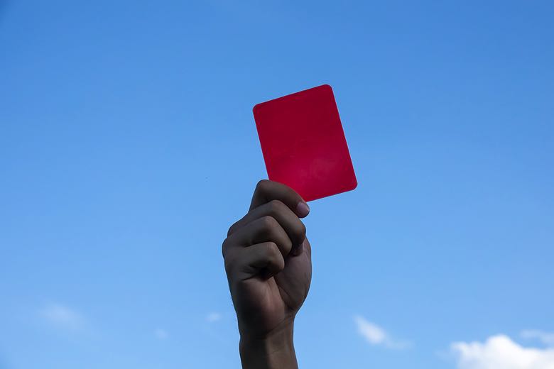 Ref holding up a red card